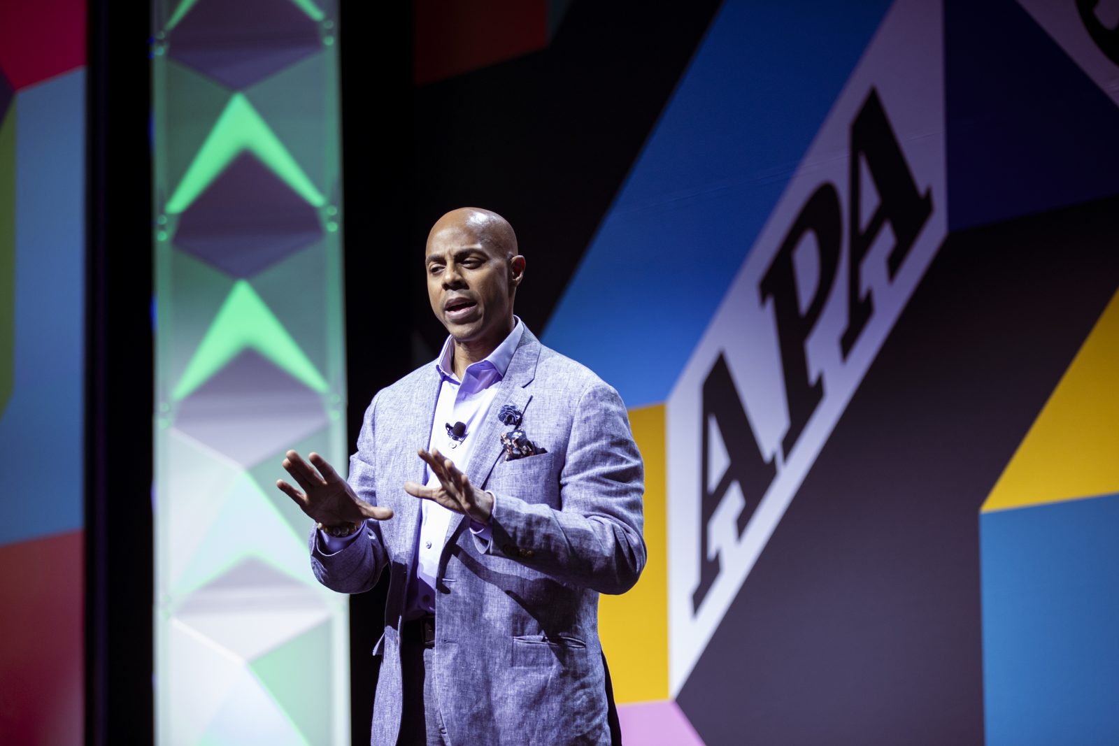 Scott C. Hollingsworth speaking on stage at the American Psychological Association convention